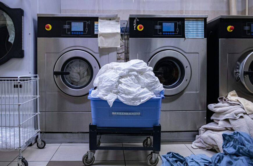 a laundry room with a washing machine and a laundry basket