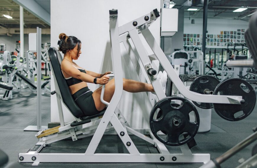 a woman sitting on a bench in a gym