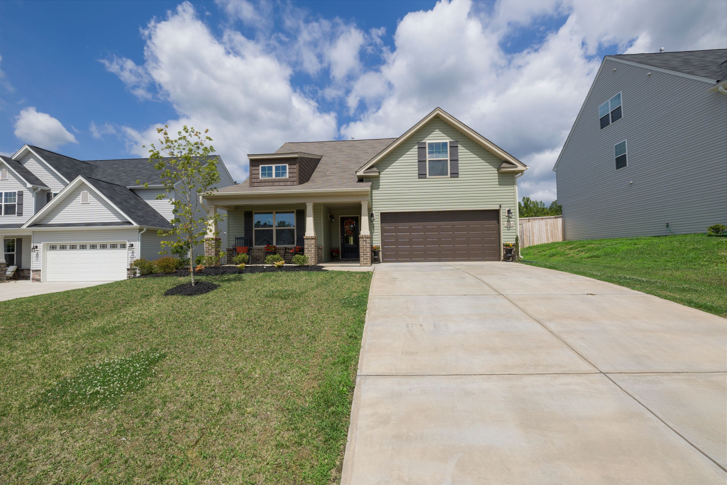 Bright modern suburban single-family house exterior with driveway and landscaping, representing a home subject to property taxes