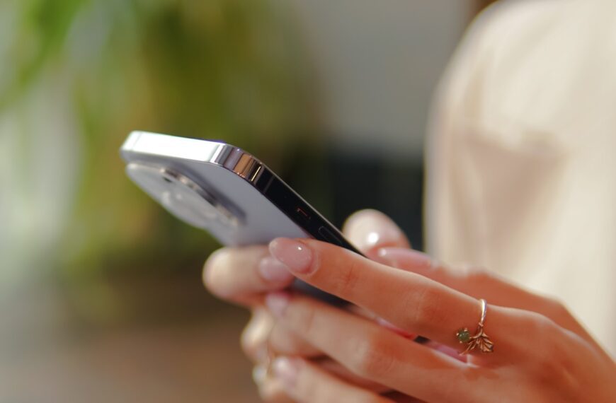 a close up of a person holding a cell phone