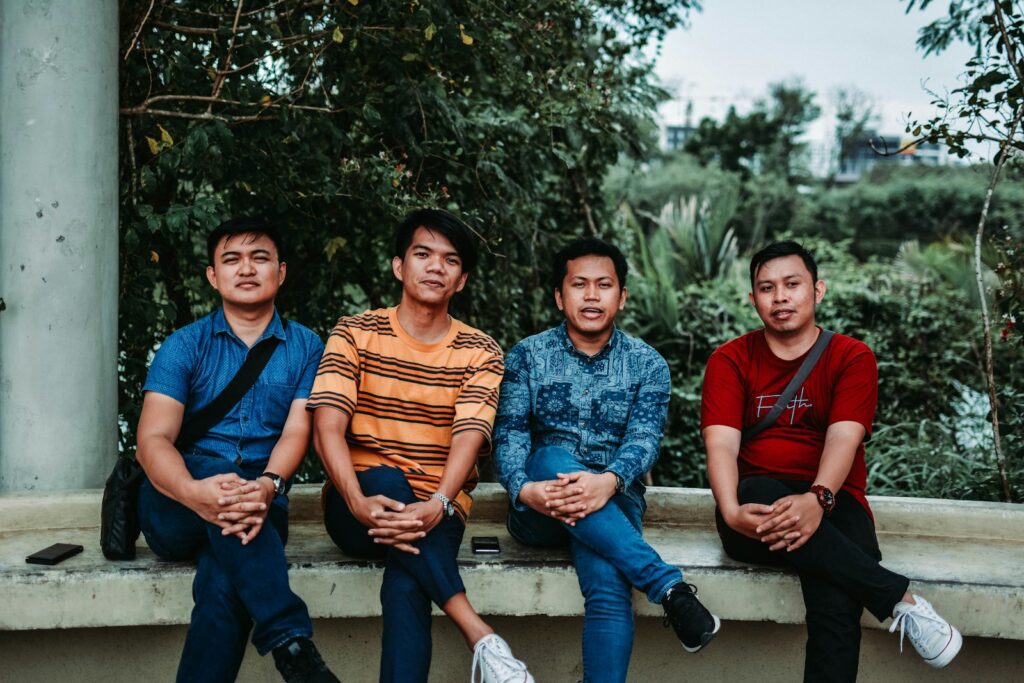 four man wearing assorted-colored shirts