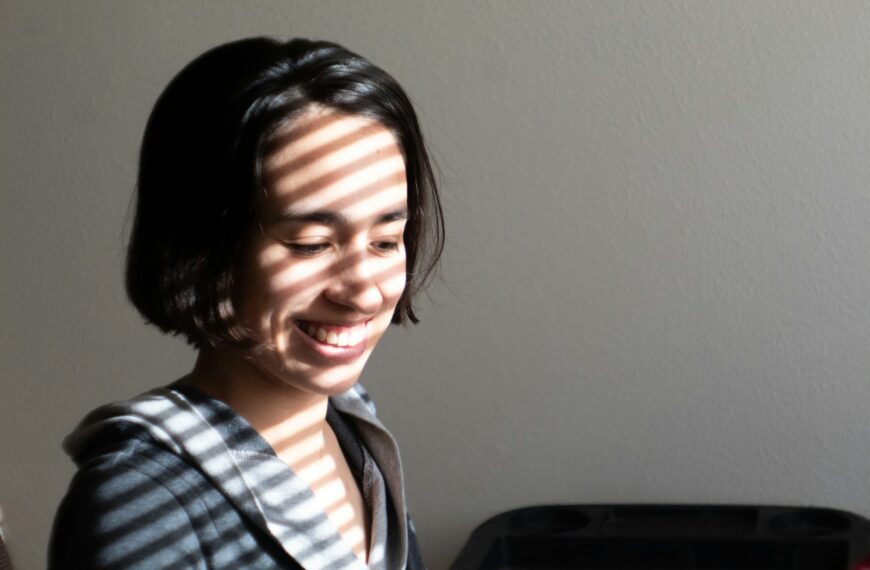 smiling boy in blue white and black plaid collared shirt