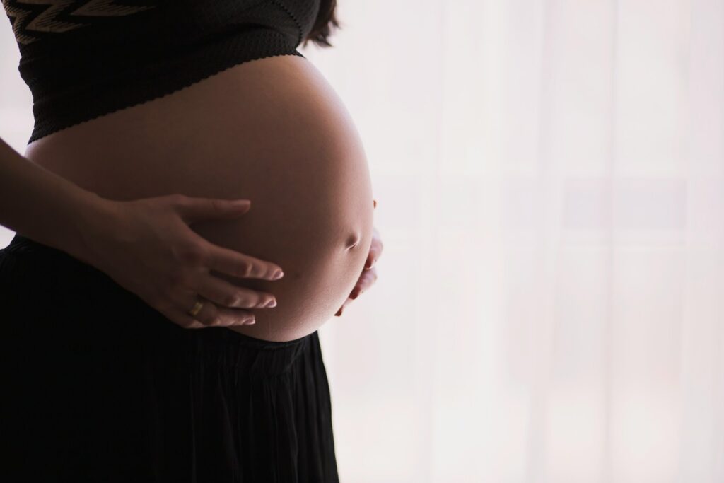 pregnant woman cradling her belly