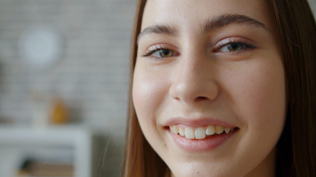 Young woman smiling with light makeup