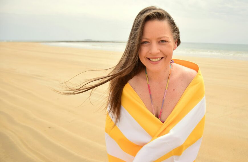 woman in yellow and white striped dress on beach
