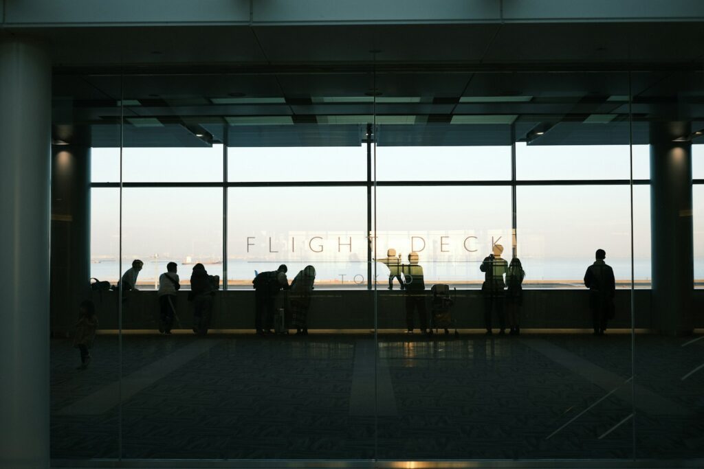 A group of people standing in front of a window