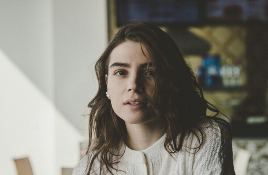 portrait photography of woman wearing knitted top