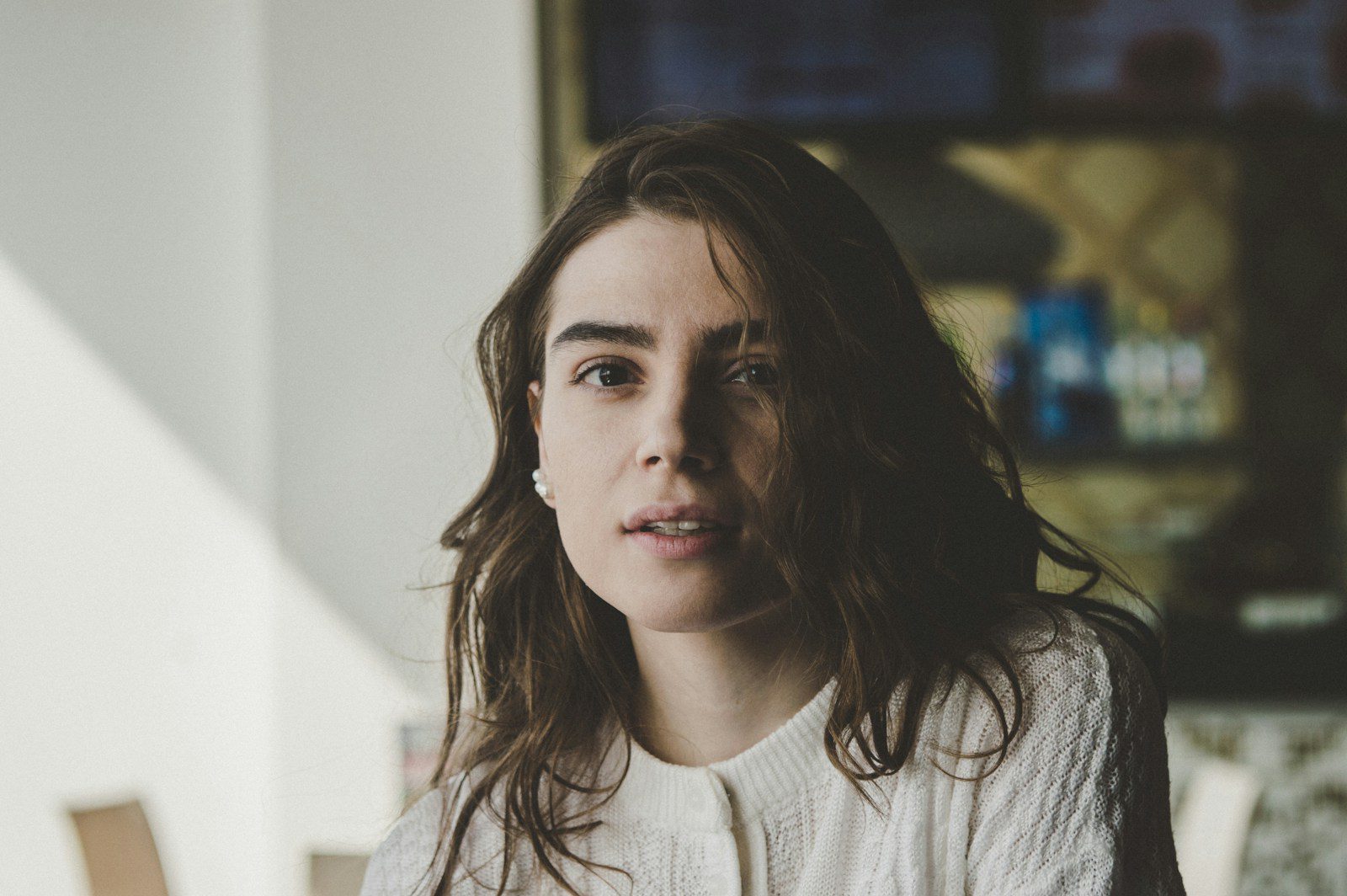 portrait photography of woman wearing knitted top