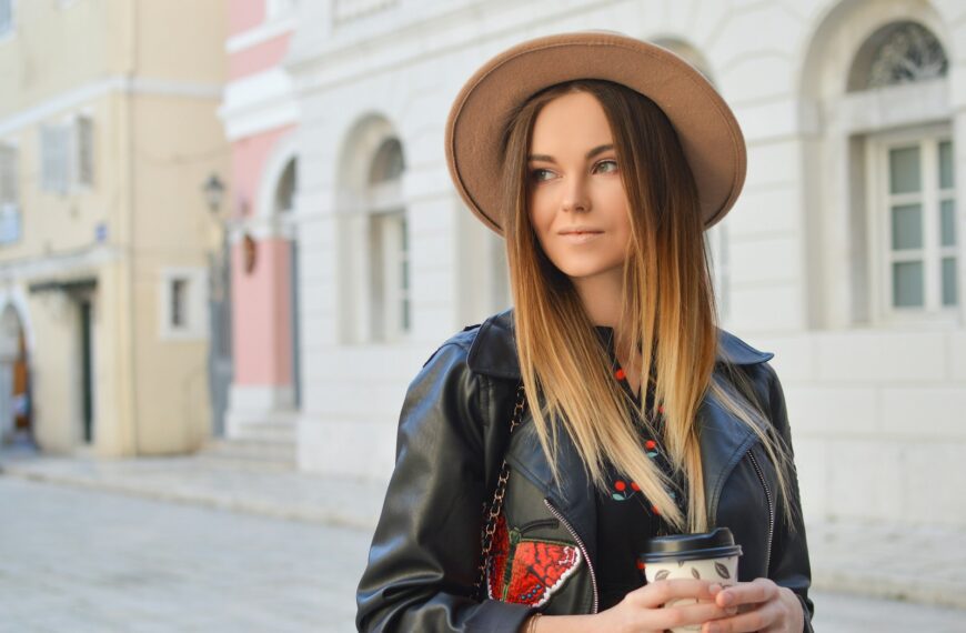 woman looking left side while holding plastic tumbler