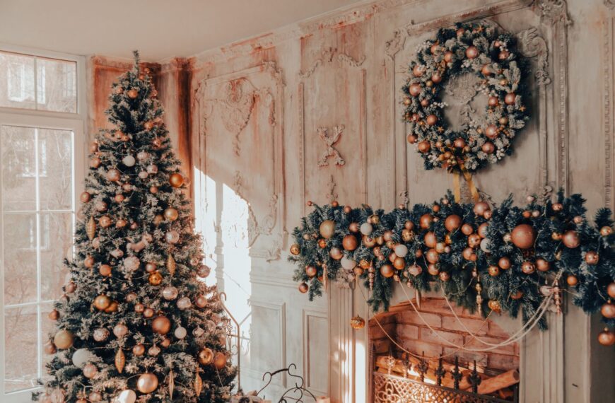 Cozy Christmas living room featuring a beautifully decorated tree, wreath, and fireplace garland.