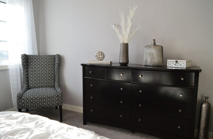 Sleek and stylish bedroom with modern black furniture and elegant decor.
