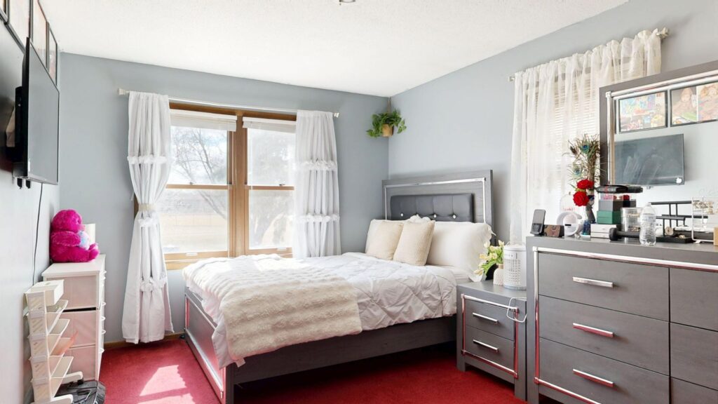 Bright and modern bedroom interior with natural light, ideal for relaxation and comfort.