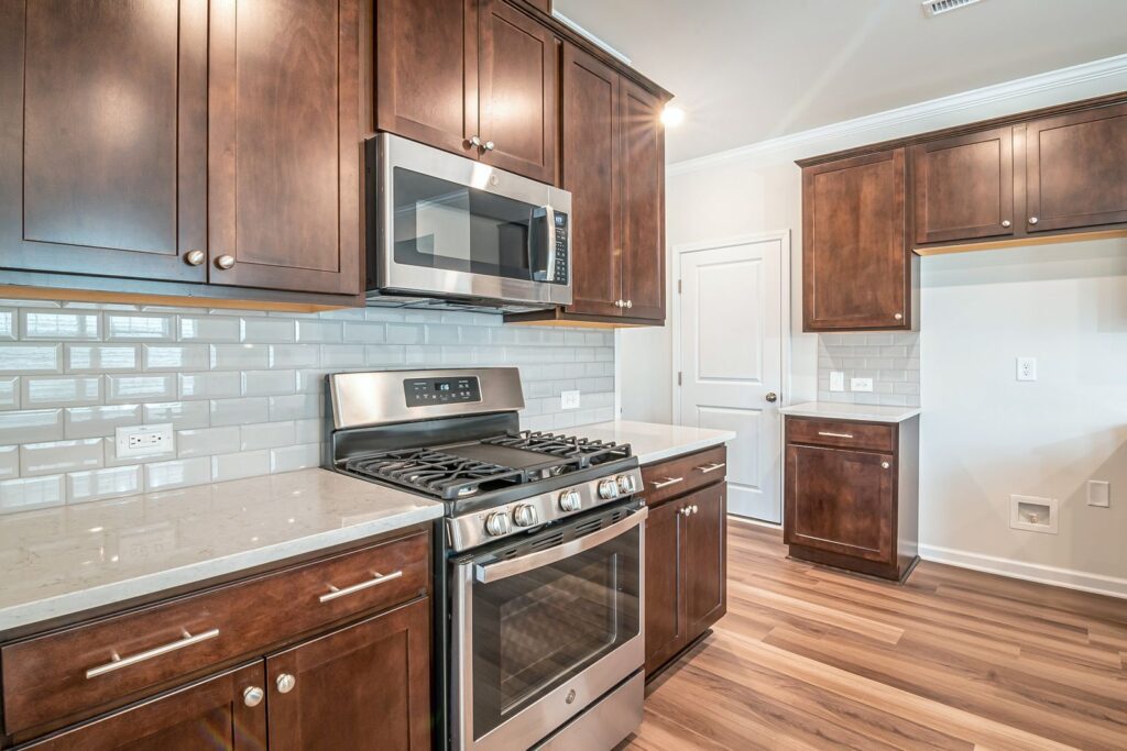 Sleek kitchen interior featuring stainless steel appliances and wooden cabinetry.
