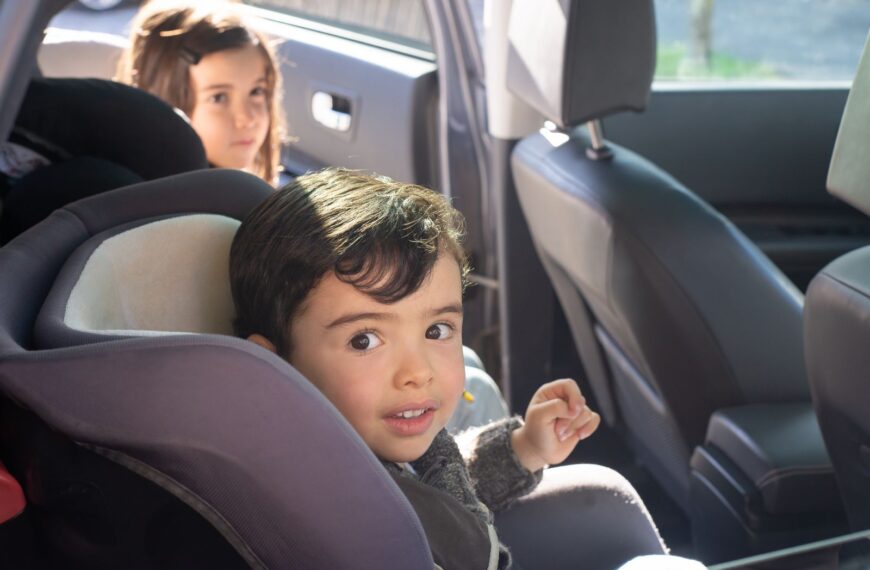Two children sitting in a car, enjoying a family ride in Portugal.