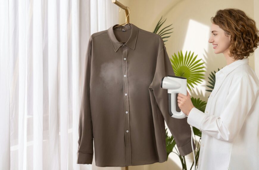 A woman using a hair dryer to dry a shirt