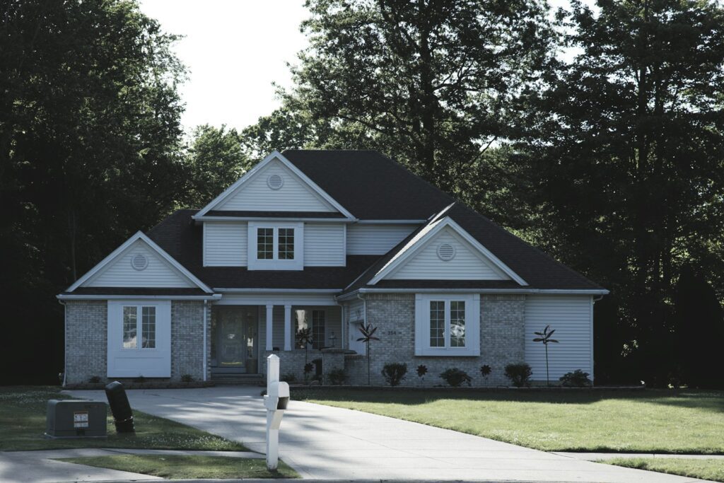Modern suburban house with a green lawn and trees