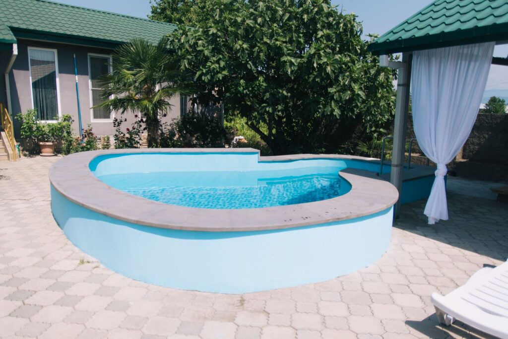 Cozy backyard with modern pool and lush greenery, ideal for relaxation.