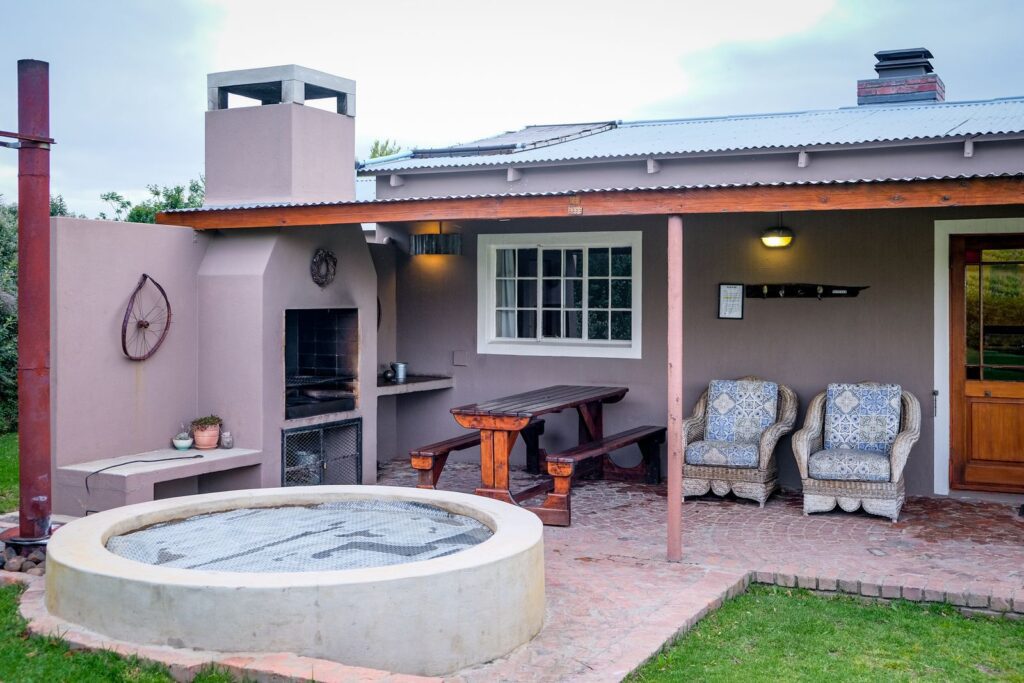 Inviting residential patio with a hot tub and comfortable seating area.