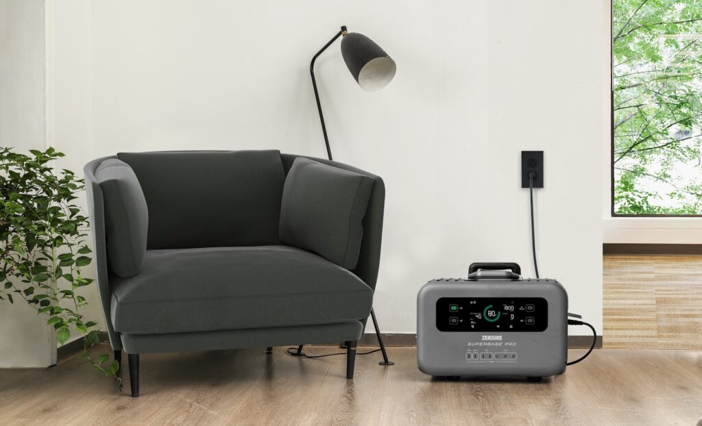 a grey chair sitting next to a black and white radio