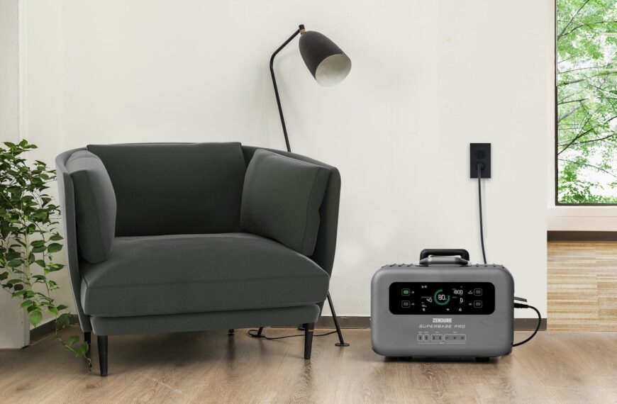 a grey chair sitting next to a black and white radio