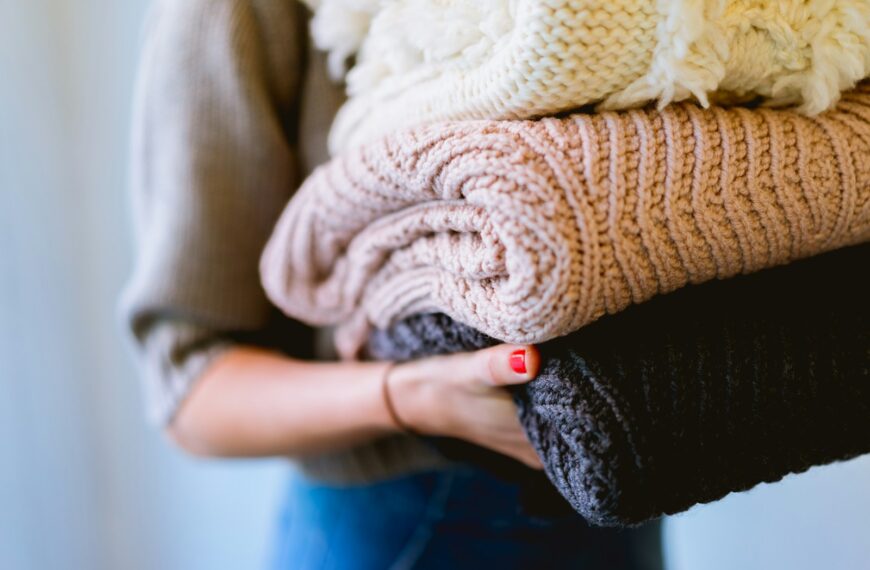 person holding knitted textiles