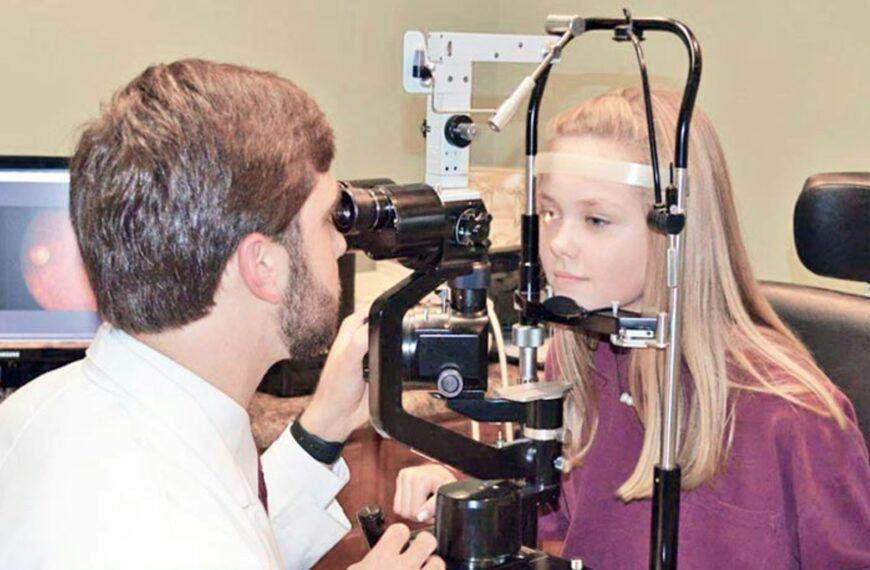 A man and a woman looking through a camera
