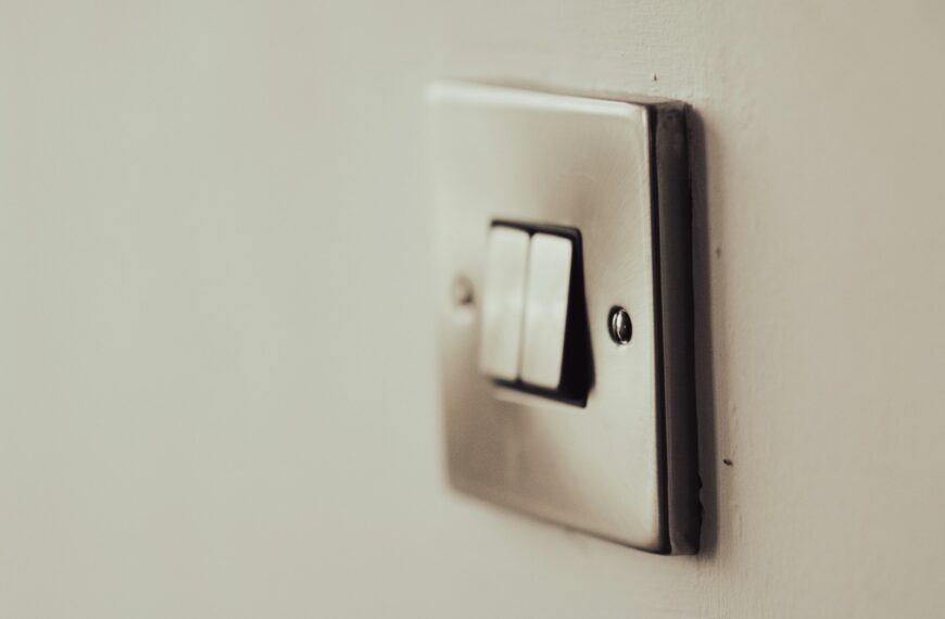 white light switch on white painted wall
