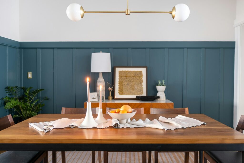 a dining room table with a bowl of fruit on it