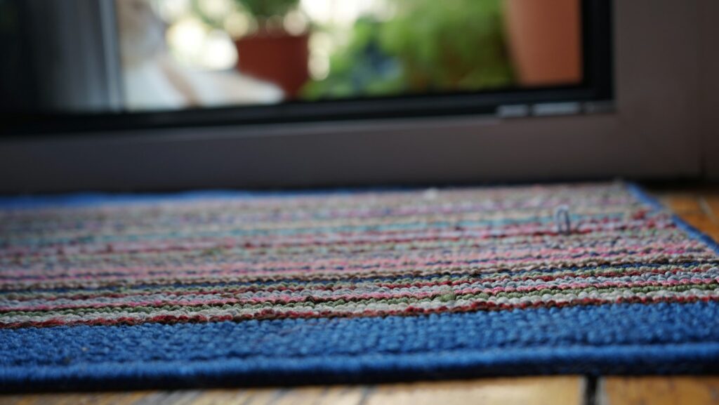 a purple rug on a wood floor