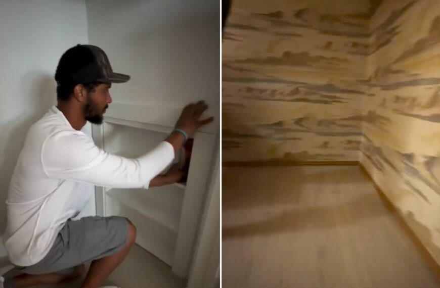 Contractor removing a closet shelving unit, beside the wood-paneled hidden space found behind it