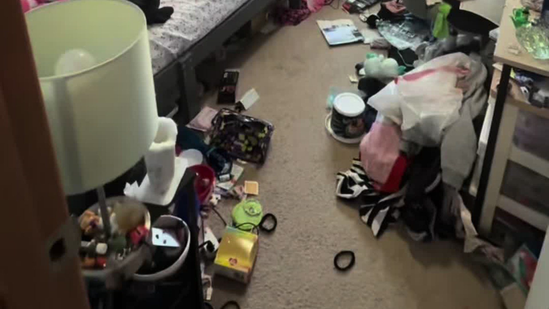A cluttered kid's bedroom floor before a professional organizer's multi-day declutter, from the organizer's own TikTok video