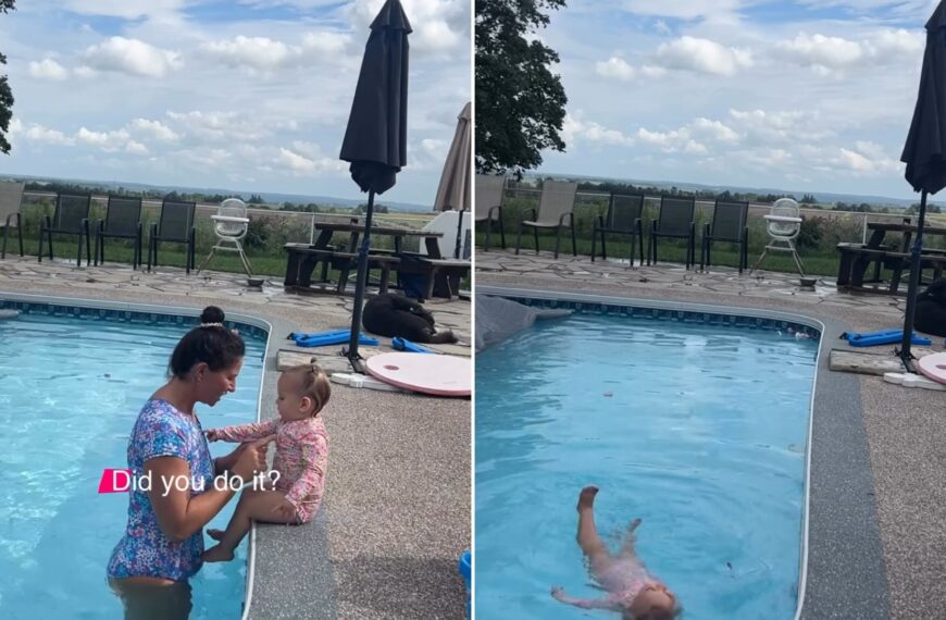 A mother holding her toddler at the edge of a backyard pool, next to the toddler floating calmly on her back, from the parent's own Instagram reel
