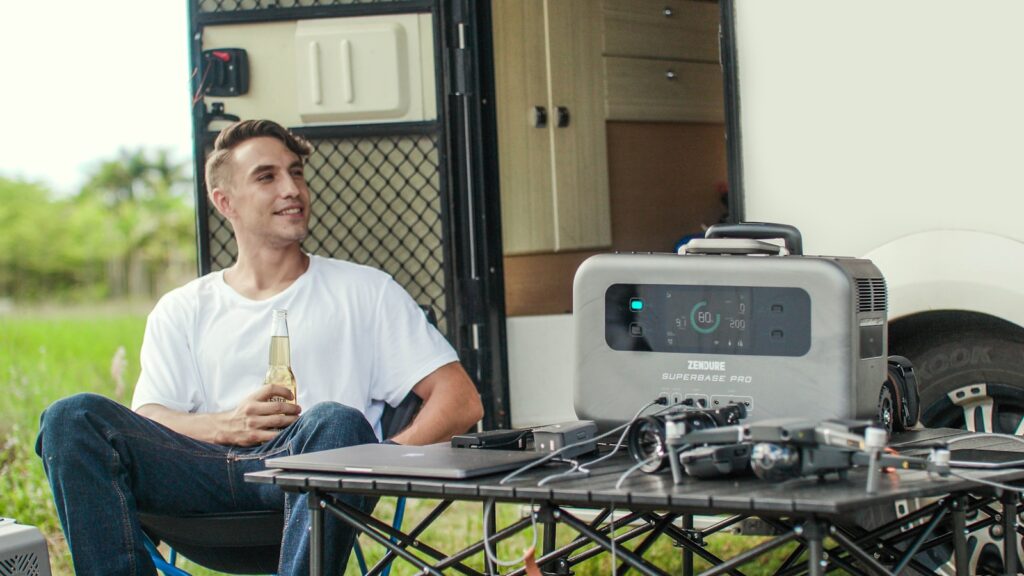 a man sitting at a table in front of a trailer