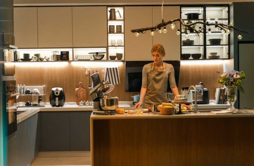 a woman standing in a kitchen preparing food