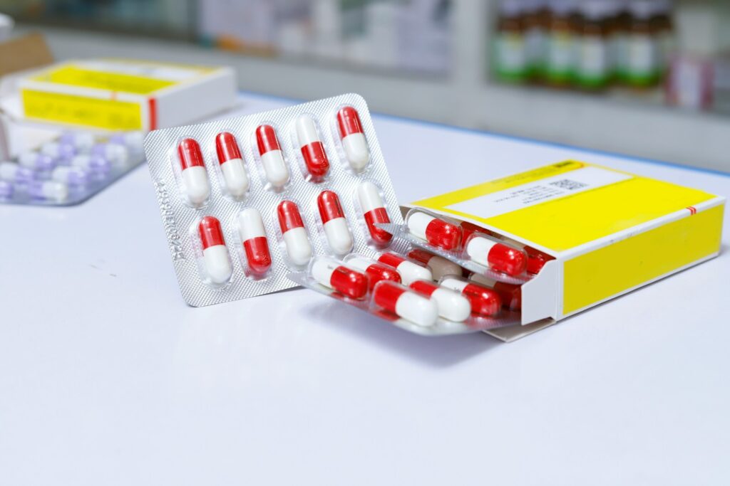 white and red medication pill blister pack