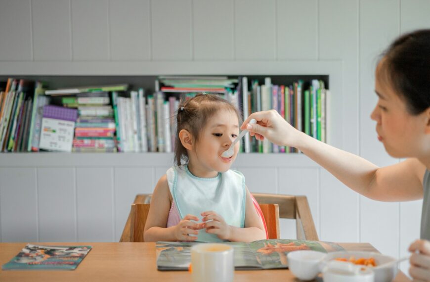 woman holding white plastic spoon