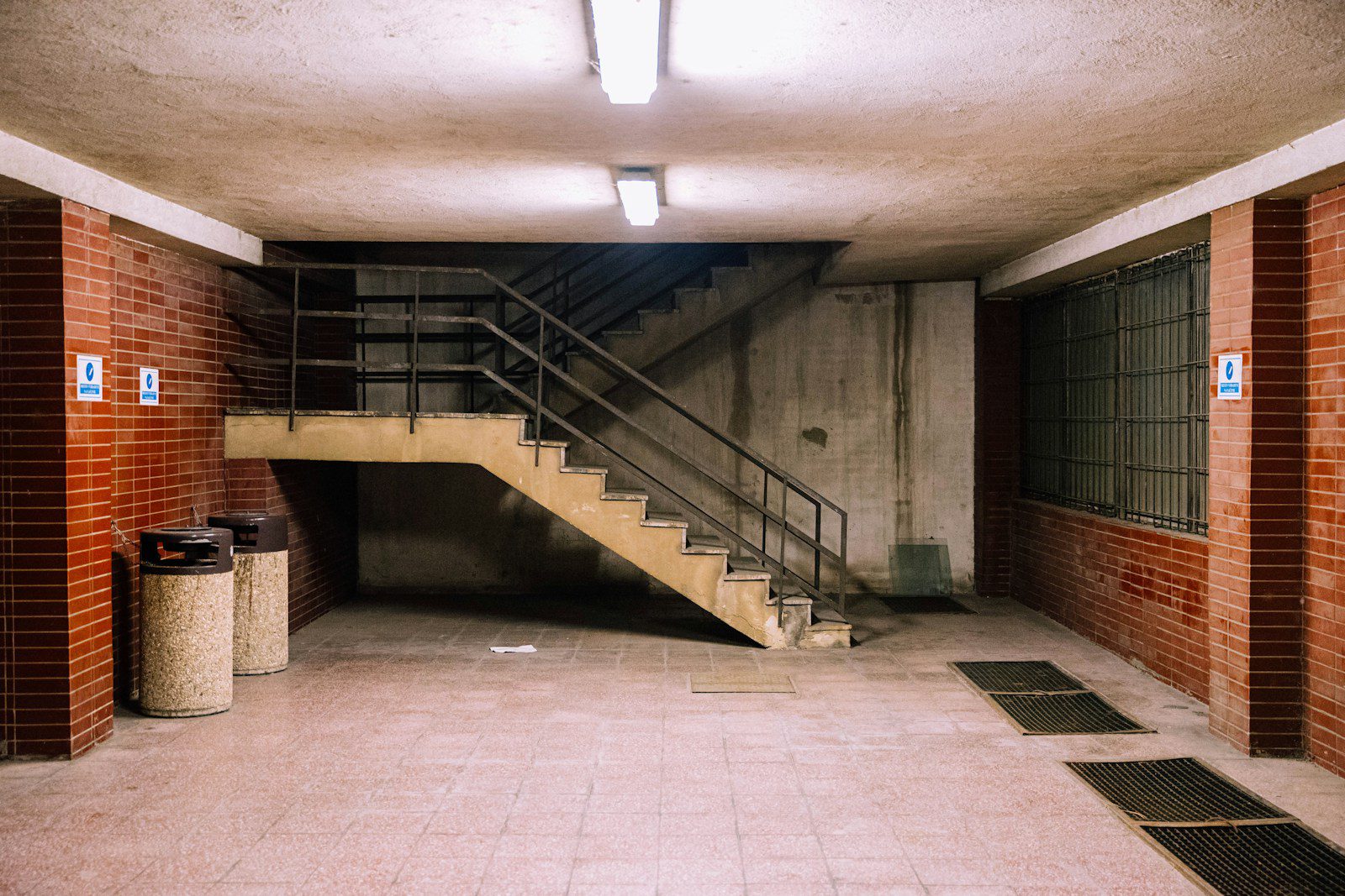 brown concrete staircase with stainless steel railings