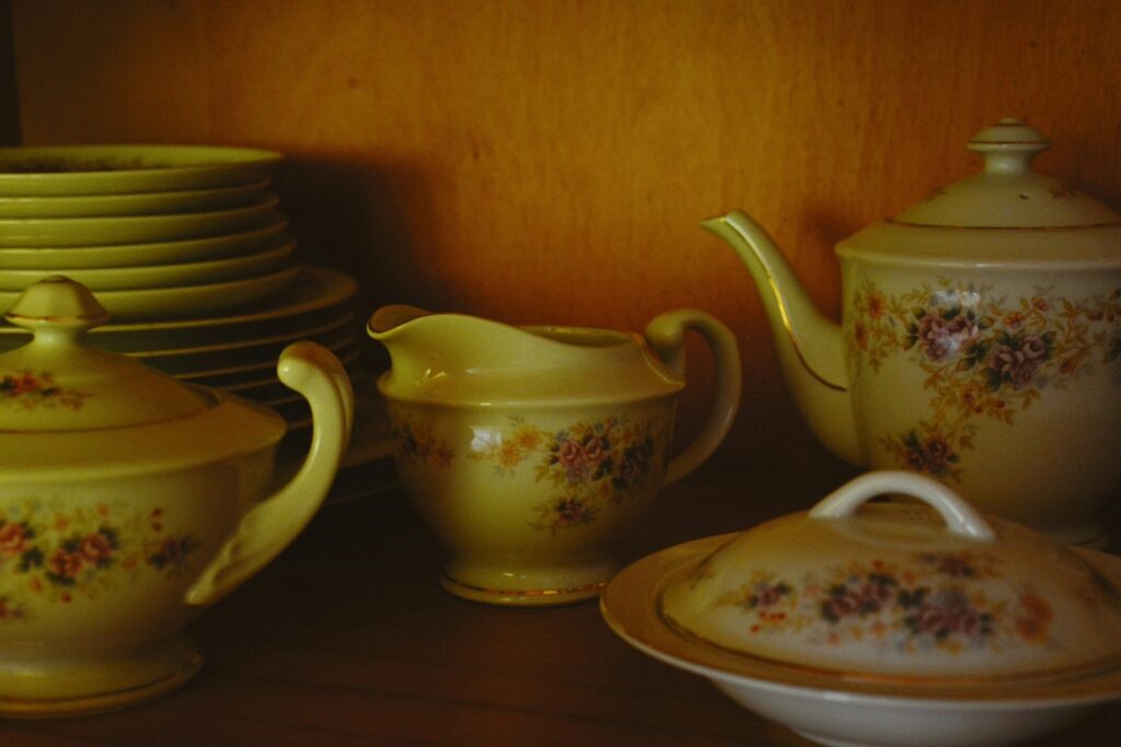 Antique floral tea set on a wooden shelf