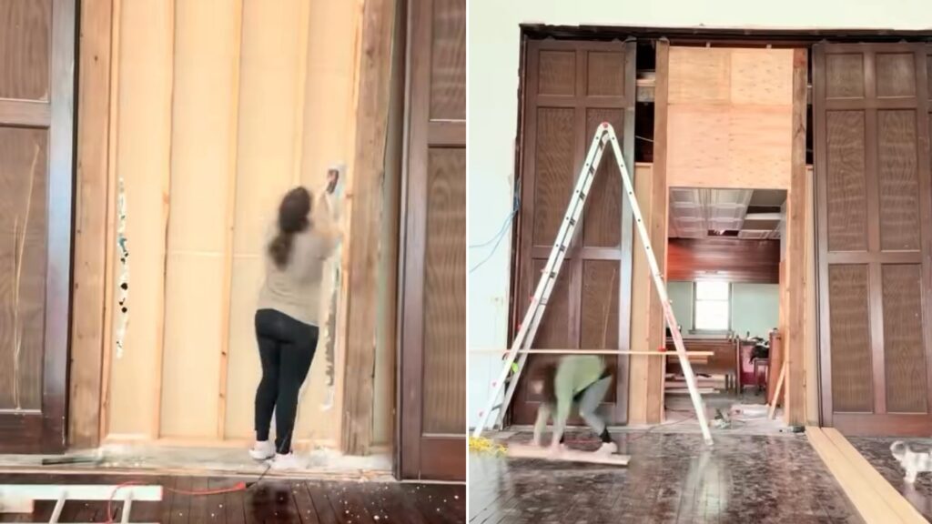 Owner tearing into drywall beside the uncovered fifteen-foot wooden pocket doors