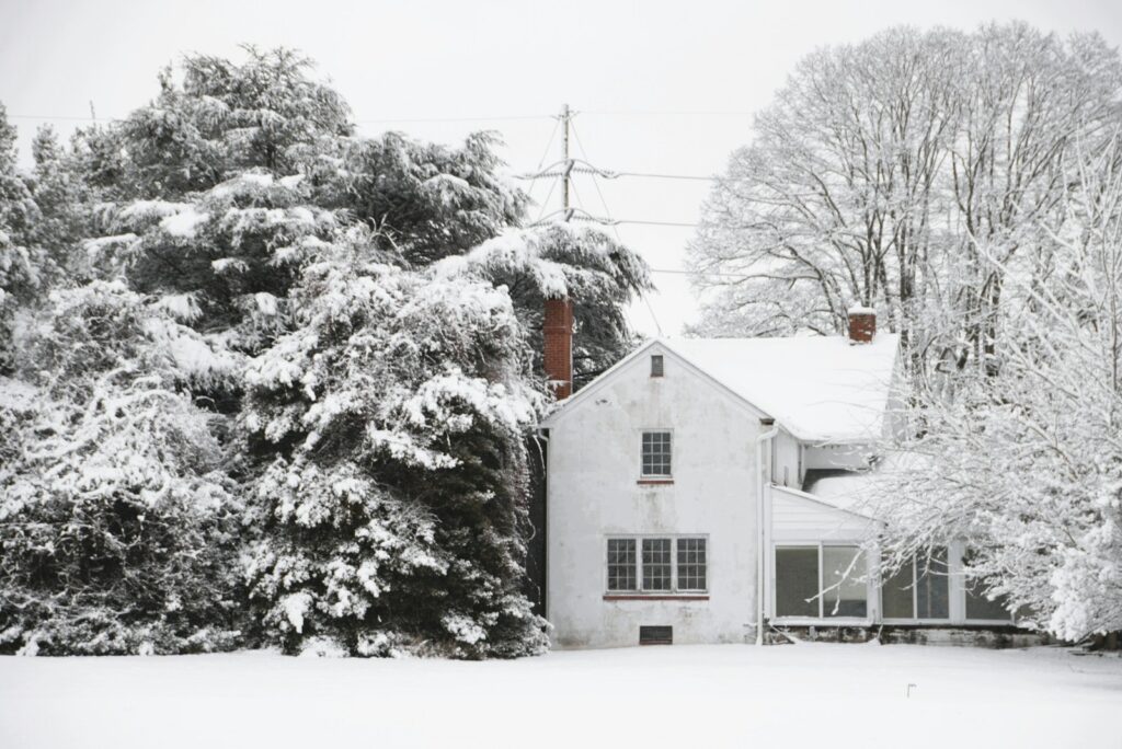 A white house covered in snow during winter