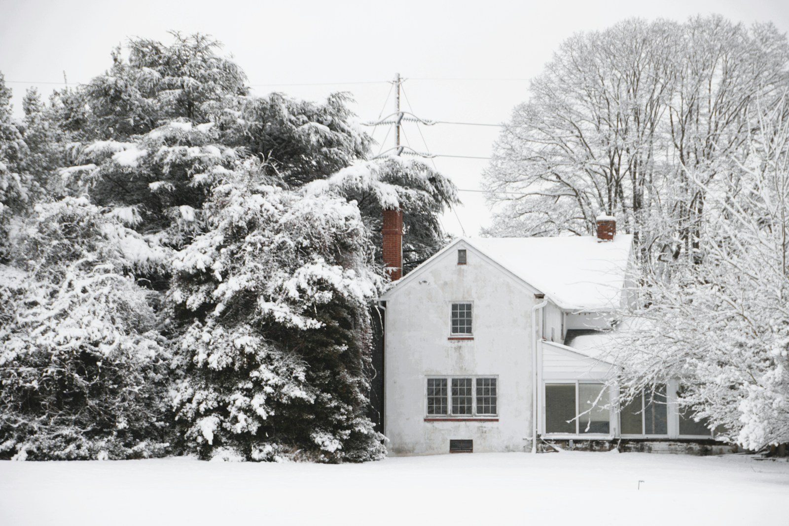 A white house covered in snow during winter