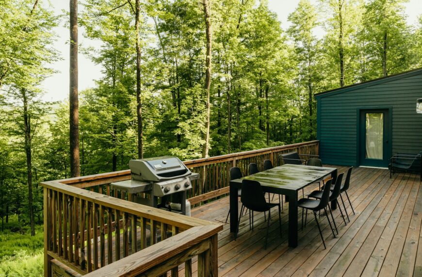 a wooden deck with a table and chairs on it