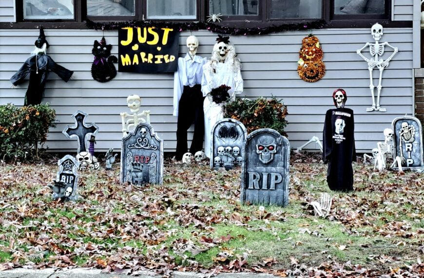 A house decorated for halloween with tombstones and decorations