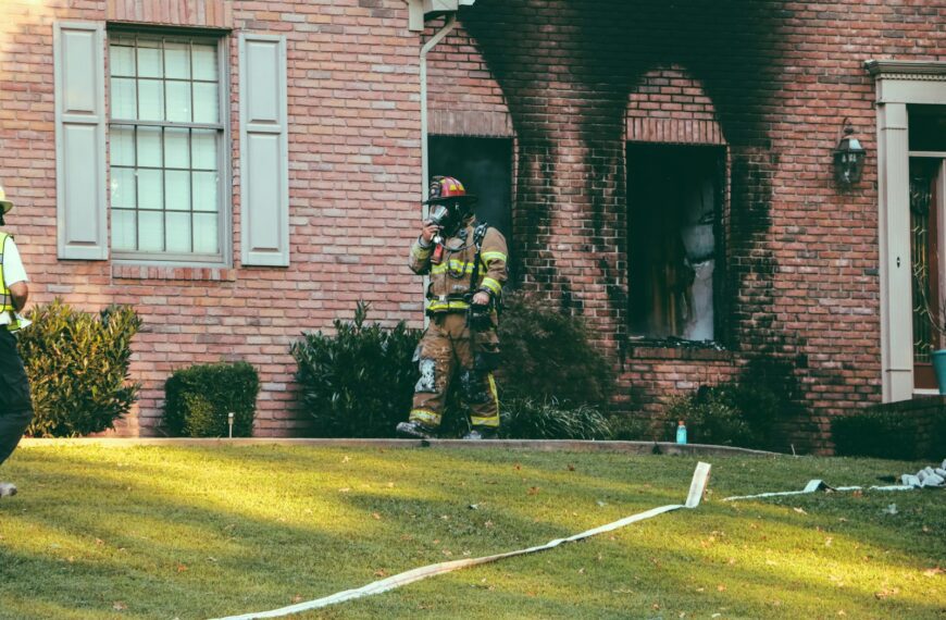 fireman walking in front of brown brick house