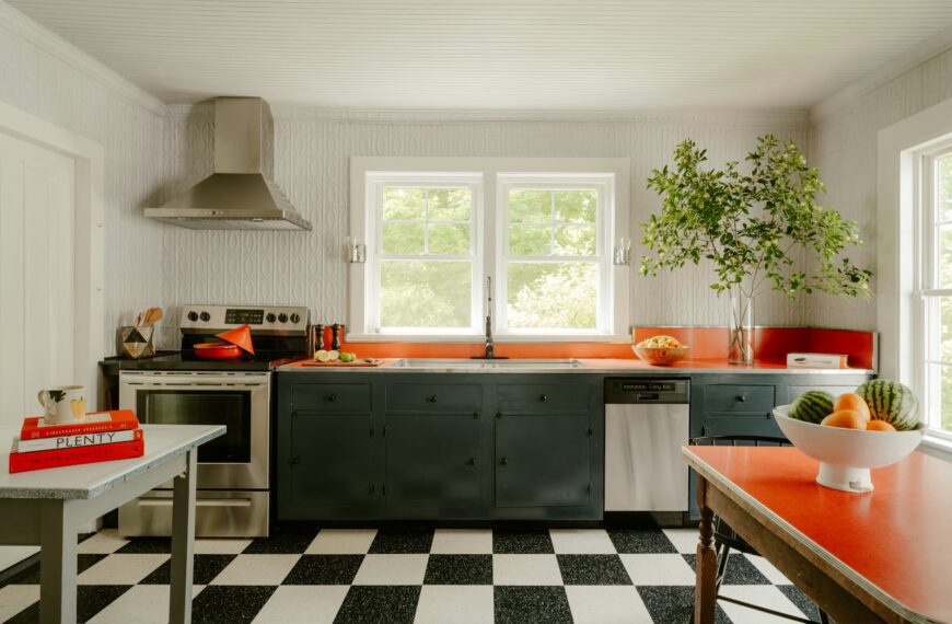 A retro kitchen features a checkered floor and orange accents