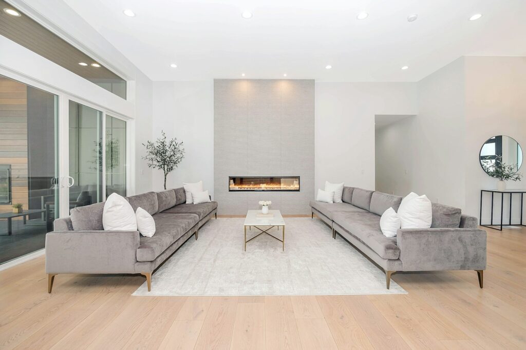 Two grey velvet sofas facing each other in a bright modern living room