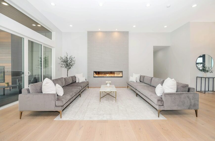 Two grey velvet sofas facing each other in a bright modern living room