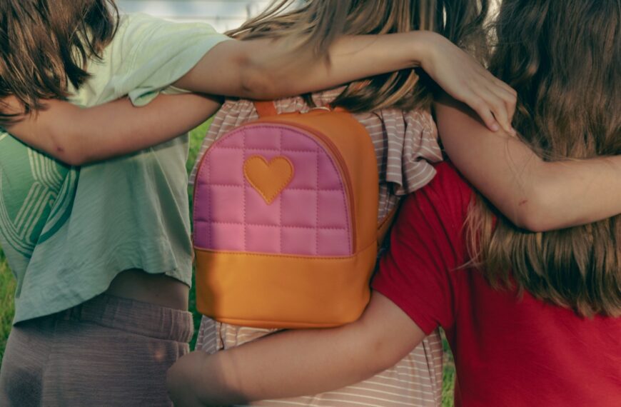 a group of young girls hugging each other