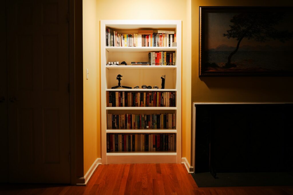 A tall bookshelf filled with books in a room