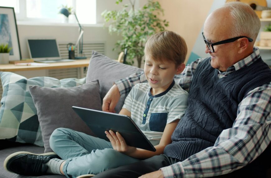 Grandfather and grandson looking at a tablet together